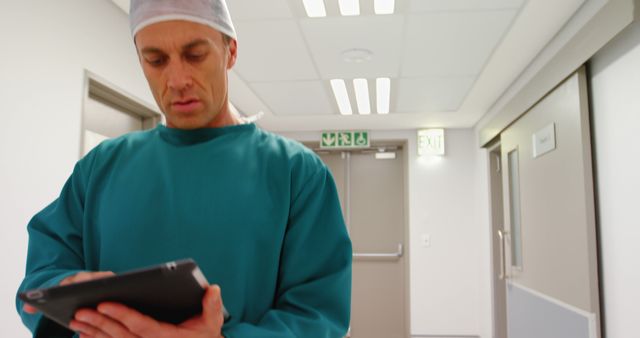 Male Surgeon Using Digital Tablet in Hospital Corridor - Download Free Stock Images Pikwizard.com