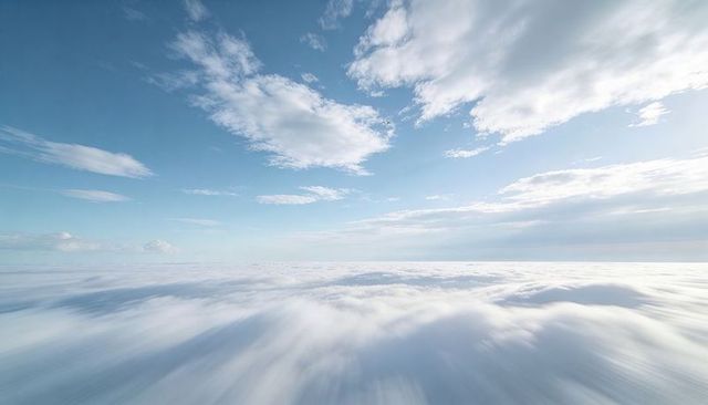 Sunlit Aerial Cloudscape Stretching to Horizon with Soft Cumulus Crests and Pale Sky