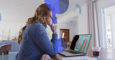 Businesswoman Analyzing Data on Laptop in Home Office Setting