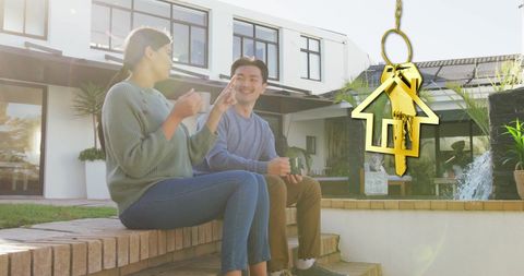 Happy Couple with House Key Embracing New Homeownership