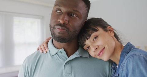 Happy Diverse Couple Embracing in Contemporary Living Room