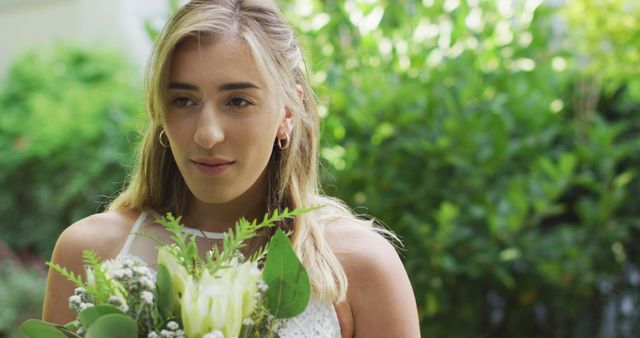 Young Woman Holding a Bouquet of Fresh Flowers Outdoors - Download Free Stock Images Pikwizard.com