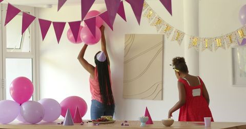 Family decorating room with balloons for celebration