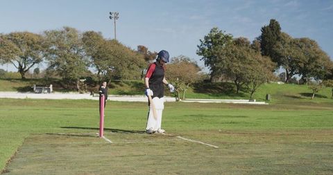 Female Cricket Player Prepared to Bat in Outdoor Match Setting