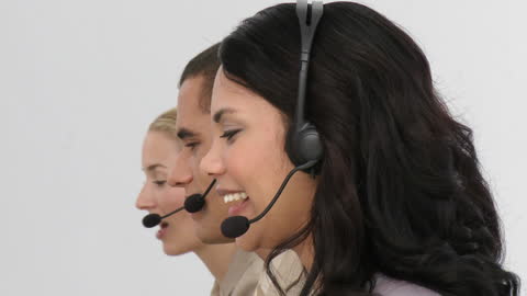 Smiling Professionals in Call Center with Headsets