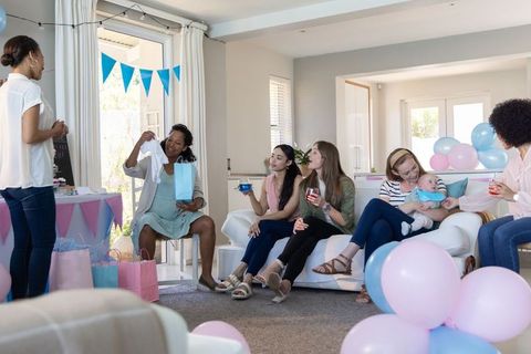 Diverse Friends Celebrating Baby Shower Party with Onesie