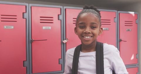 Smiling Girl in Front of School Lockers Ready for Class