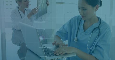 Medical Professionals Analyzing Digital Data on Laptop