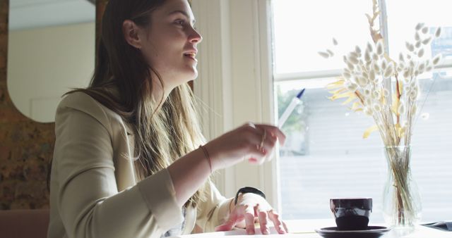 Young Woman Enjoying Coffee in Cozy Cafe by the Window - Download Free Stock Images Pikwizard.com