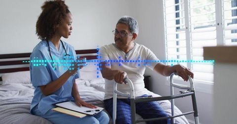 Homecare nurse consulting senior with walker at bedside, telehealth monitoring overlay