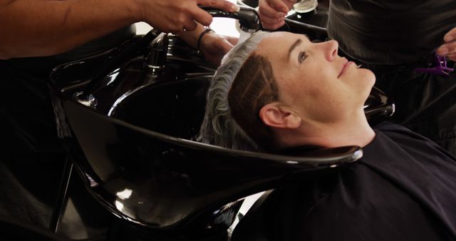 Young Person Enjoying Hair Treatment in a Salon - Download Free Stock Images Pikwizard.com