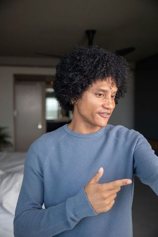 Casual Home Relaxation: Mid Adult Man in Cozy Blue Sweater