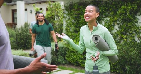 Diverse Friends Enjoying Outdoor Yoga in Lush Backyard