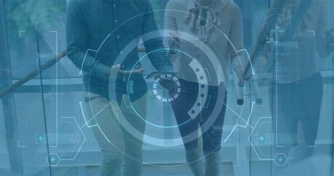 Business professionals walking through modern office corridor with futuristic hud overlay