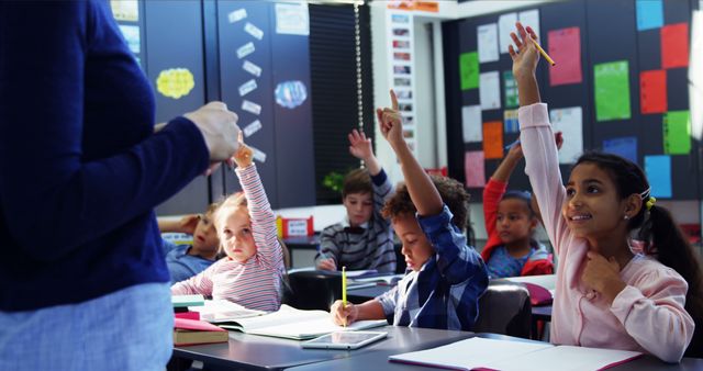 Enthusiastic Elementary Students Raising Hands in Class - Download Free Stock Images Pikwizard.com