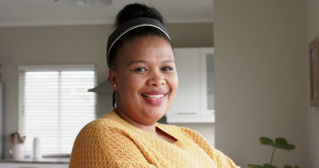 Smiling African American Woman in Yellow Sweater at Home - Download Free Stock Images Pikwizard.com