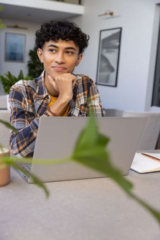 Asian Man Working with Laptop in Modern Home Office