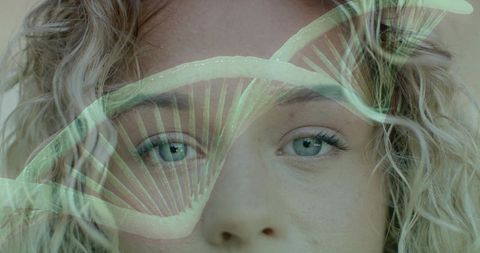Curly blonde woman headshot with translucent fern overlay, teal-blue eyes, double exposure