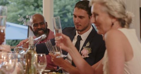 Guests toasting lively wedding reception celebrations