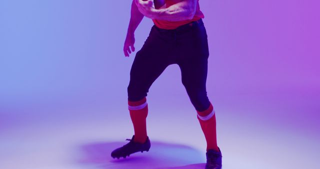 Image of caucasian american football player in helmet with ball over neon purple background. American football, sports and competition concept.