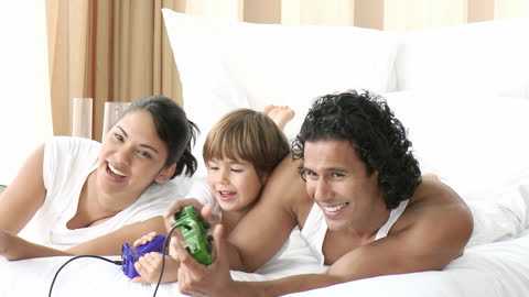 Family Time Playing Video Games on Bed