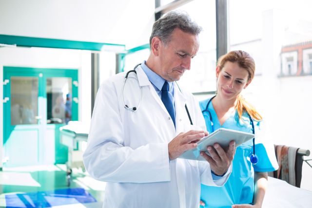 Doctor and Nurse Discussing Patient Information on Digital Tablet - Download Free Stock Photos Pikwizard.com