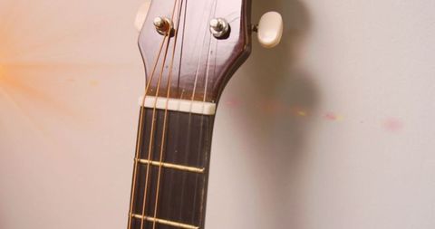 Close-Up of Acoustic Guitar Headstock and Tuning Pegs