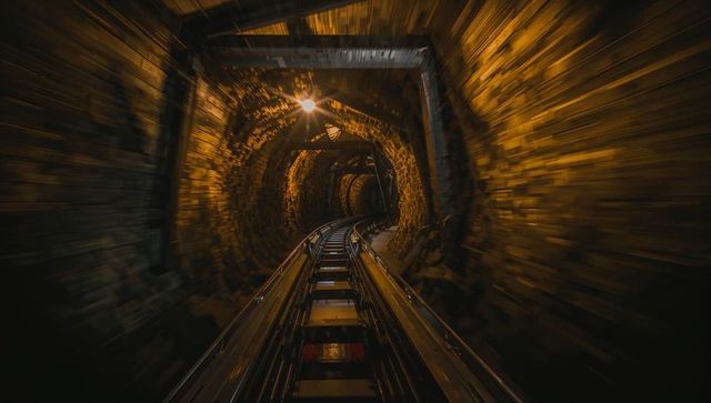 Vintage Underground Tunnel with Curving Metal Rails