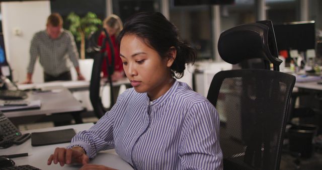 Asian businesswoman sitting at desk and using computer at office. Business, communication, office and work.