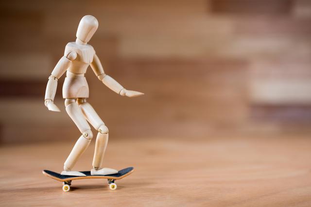 Conceptual image of figurine skateboarding on a wooden floor