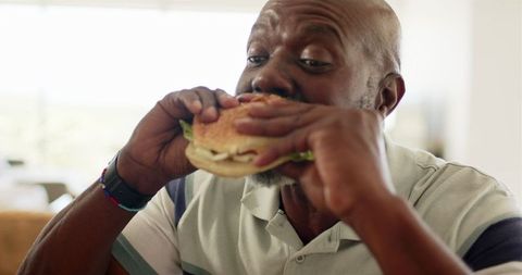 Mature Man Enjoying Burger at Home - Download Free Stock Images Pikwizard.com