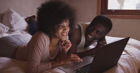 Couple Enjoying Relaxed Moment Browsing Laptop in Cozy Home