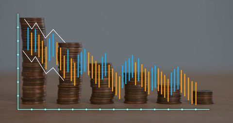 Stacks of Coins with Economic Data Graph in Business Finance