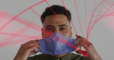 Male adjusting blue-purple face mask with red digital data arcs, modern safety headshot