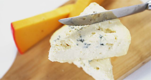 Close-up of Knife Cutting Blue Cheese on Wooden Board - Download Free Stock Images Pikwizard.com