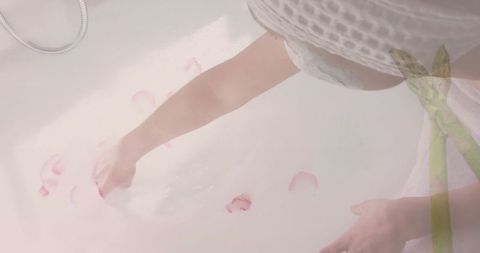 Woman Arranging Rose Petals in Bathtub for Relaxing Spa Experience