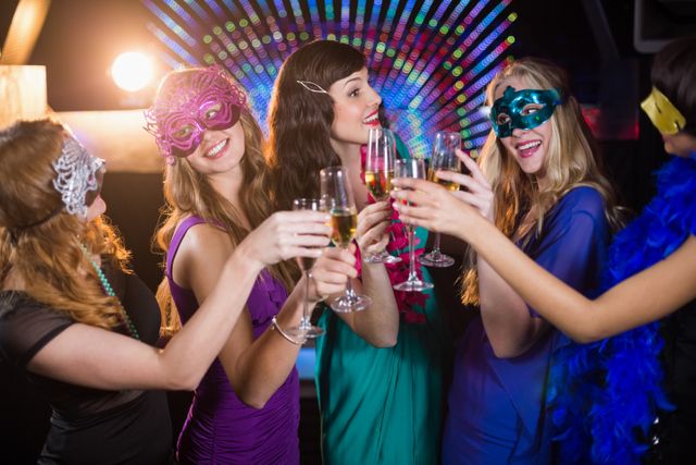 Group of Friends Celebrating with Champagne at Masquerade Party - Download Free Stock Photos Pikwizard.com