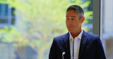 Businessman Delivering Speech at Conference Room