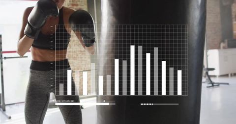 Woman training with punching bag enhanced with digital charts