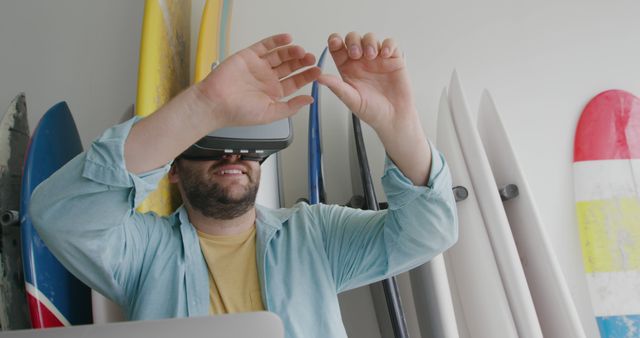 Man Experiencing Virtual Reality Simulation Near Surfboards - Download Free Stock Images Pikwizard.com
