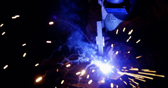 Industrial Welding Process with Sparks and Smoke in Dark Environment - Download Free Stock Images Pikwizard.com