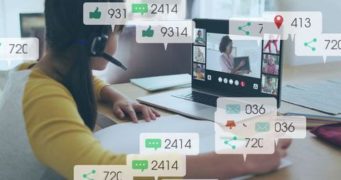 Child learning remotely with headset at home desk, engaging in virtual classroom session