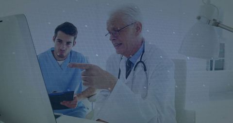 Experienced Doctor Mentoring Young Trainee in Modern Medical Office