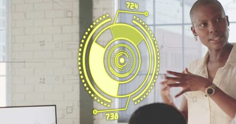 Woman presenting futuristic hud data visualization during team meeting in modern office
