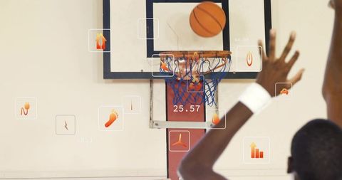 Shooting basketball with augmented reality analytics overlay over rim and backboard