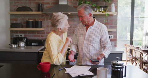 Senior Couple Managing Finances in Modern Kitchen Setting - Download Free Stock Images Pikwizard.com