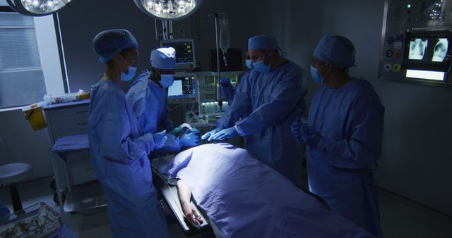 Surgeons Performing Operation Under Blue Light in Operating Room - Download Free Stock Images Pikwizard.com