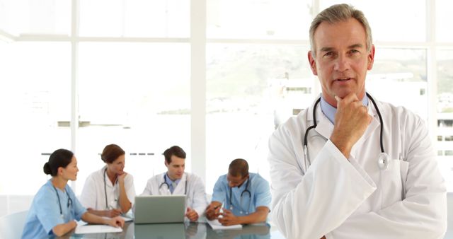 Confident Doctor Leading Medical Team in Hospital Meeting - Download Free Stock Images Pikwizard.com