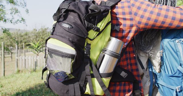 This image features two backpackers hugging outdoors, emphasizing themes of adventure, travel, and friendship. Their camping gear and backpacks highlight the spirit of exploration and connection with nature. This can be used in content related to outdoor activities, travel blogs, adventure tourism, and advertisements for hiking and camping gear.