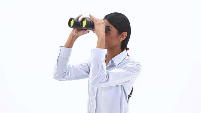 Businesswoman using binoculars symbolizes visionary thinking and looking for future opportunities. Ideal for illustrating concepts of market research, foresight, and strategic planning in corporate presentations, articles, and advertisements.